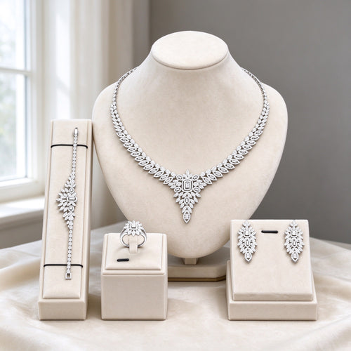 The Tiara Wedding Suite silver-tone clear CZ four-piece V-point fan necklace, earrings, bracelet and ring on ivory velvet bust