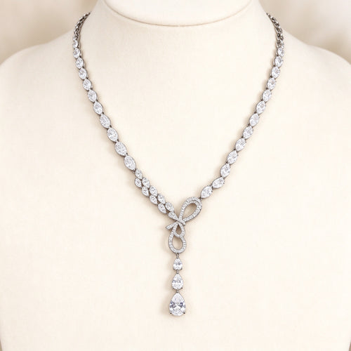 The Cameron Bridal Set – silver-tone pavé CZ ribbon-loop Y-necklace and pear-drop earrings on ivory