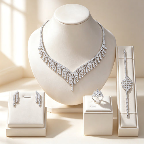 The Moss Bridal Set — silver-tone CZ cascading V fringe necklace, long drop earrings, tennis bracelet, and solitaire ring on ivory velvet bust