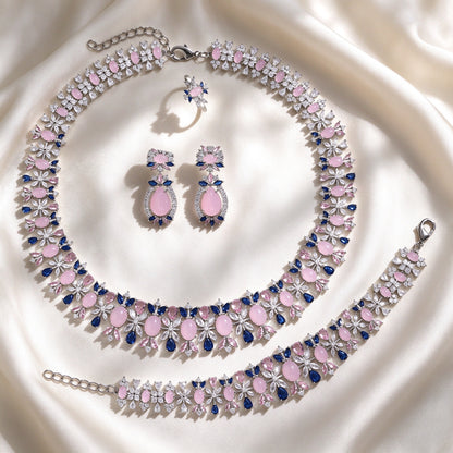 The Calliope Bridal Set — silver-tone floral statement collar necklace, teardrop earrings, station bracelet and cluster ring in pink cabochon CZ on ivory silk