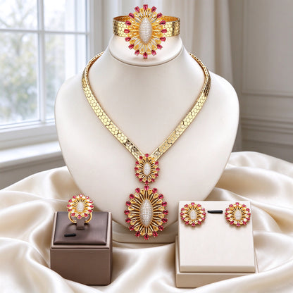 The Solstice Bridal Set gold honeycomb collar with red-and-champagne sunburst pendants, earrings, ring and cuff on ivory silk