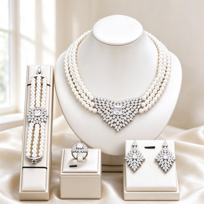 The Vale Bridal Parure 3-strand white pearl necklace with V-shaped CZ pendant on ivory bust