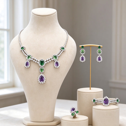 The Crown Crystal Parure silver-tone green and purple CZ four-piece necklace, earrings, brooch and ring on ivory velvet bust