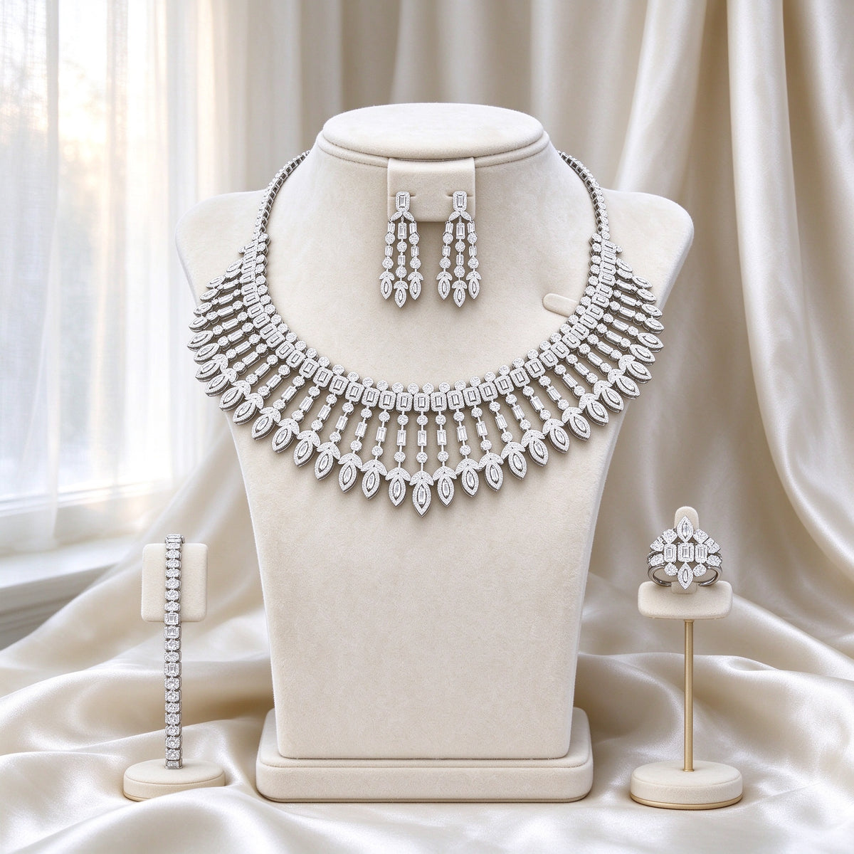 The Jasmine Bridal Set — silver-tone statement bib necklace with graduated marquise fringe, chandelier earrings, tennis bracelet, and cocktail ring on ivory velvet bust form