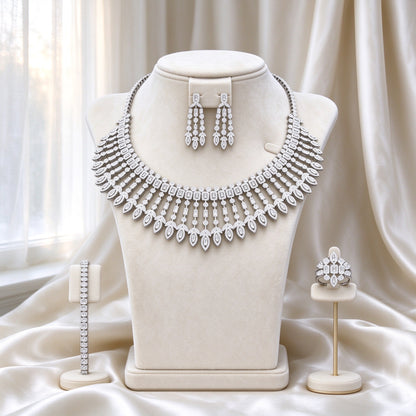 The Jasmine Bridal Set — silver-tone statement bib necklace with graduated marquise fringe, chandelier earrings, tennis bracelet, and cocktail ring on ivory velvet bust form