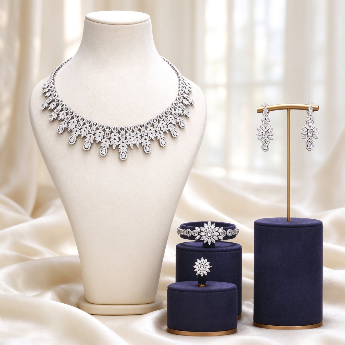 The Lyra Crystal Parure — silver-tone art-deco openwork fringe collar necklace, linear drop earrings, station bracelet and radial flower ring on ivory silk