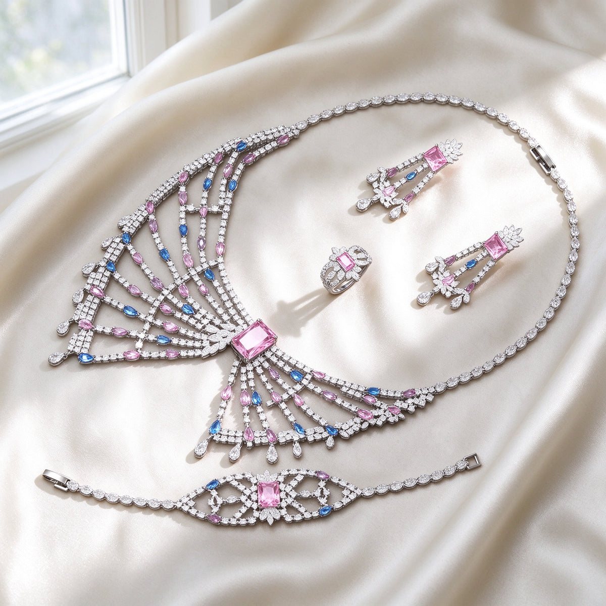 The Equinox Crystal Parure silver-tone pink CZ fan-fringe bib necklace, chandelier earrings, cluster ring and lace bracelet on ivory silk