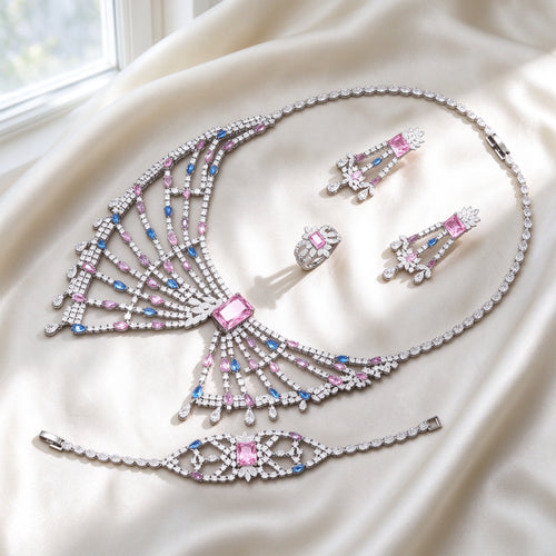 The Equinox Crystal Parure silver-tone pink CZ fan-fringe bib necklace, chandelier earrings, cluster ring and lace bracelet on ivory silk