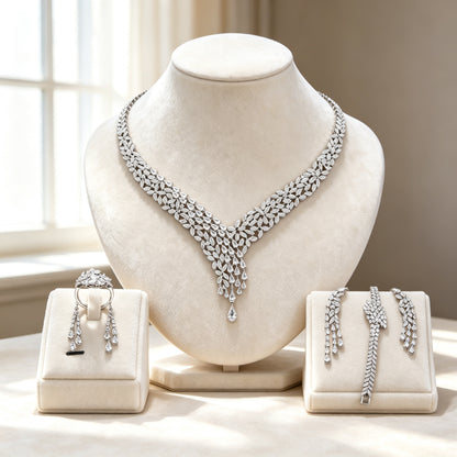 The Peony Bridal Set — silver-tone cubic zirconia V-necklace with teardrop fringe, drop earrings, bracelet and ring on ivory velvet