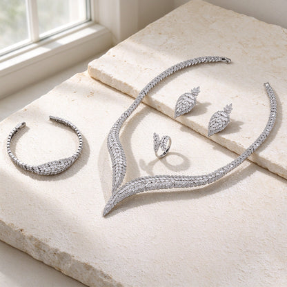 The Midnight Bridal Set — silver-tone marquise CZ leaf jewelry on warm ivory stone