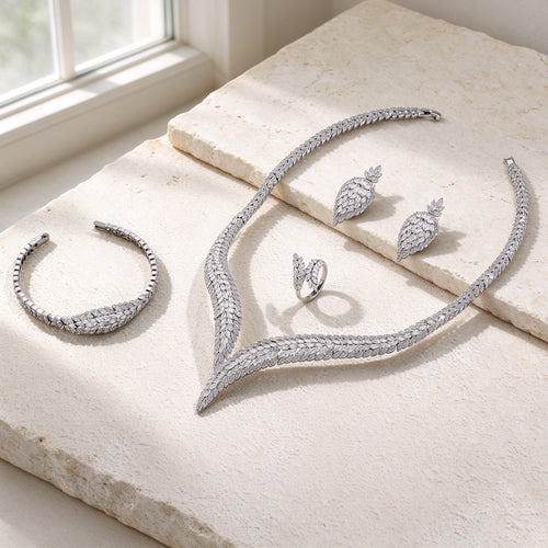 The Midnight Bridal Set — silver-tone marquise CZ leaf jewelry on warm ivory stone