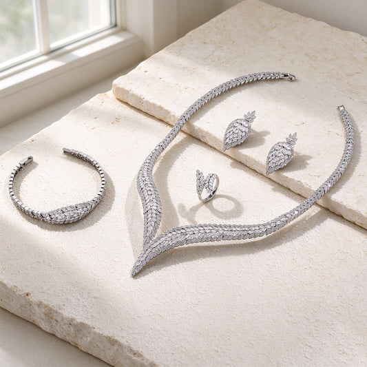The Midnight Bridal Set — silver-tone marquise CZ leaf jewelry on warm ivory stone