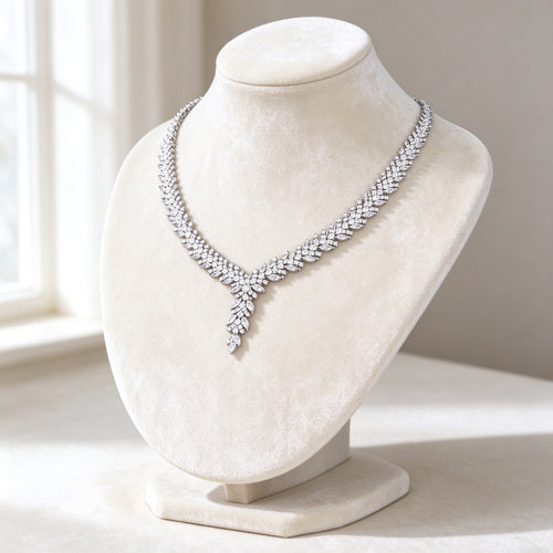 The Apex Crystal Parure marquise CZ V-line necklace on an ivory velvet bust