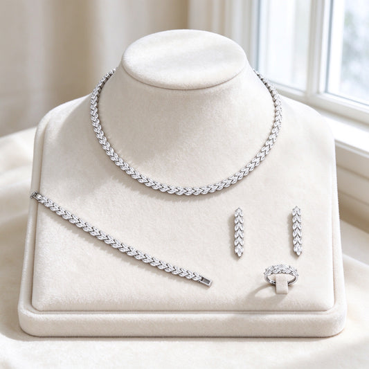 The Thorn Wedding Suite — silver-tone marquise-leaf vine collarette necklace, matching bracelet, linear drop earrings and leaf-band ring fully paved with clear cubic zirconia on ivory velvet