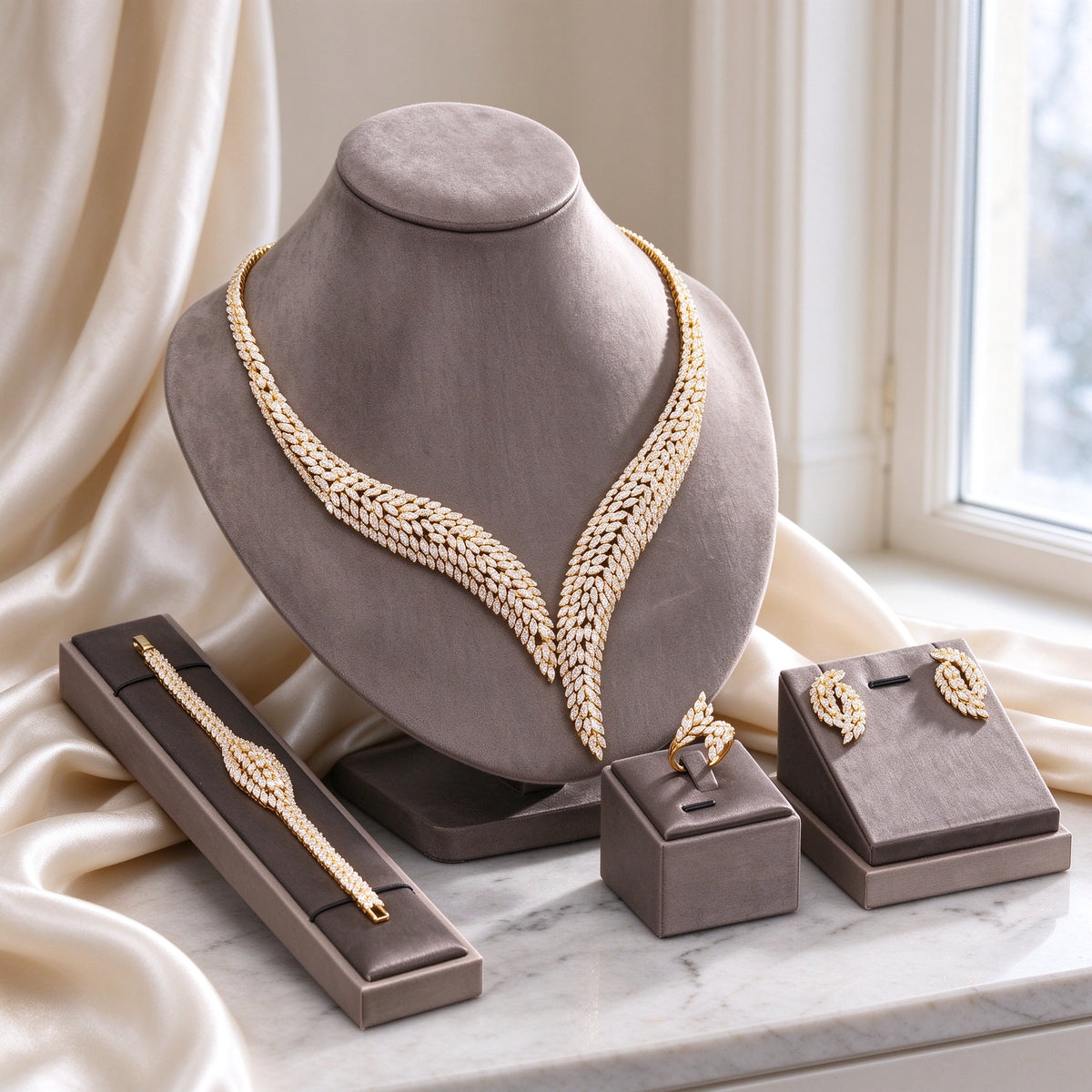 The Dawn Bridal Parure gold-tone marquise CZ necklace set on warm grey velvet bust