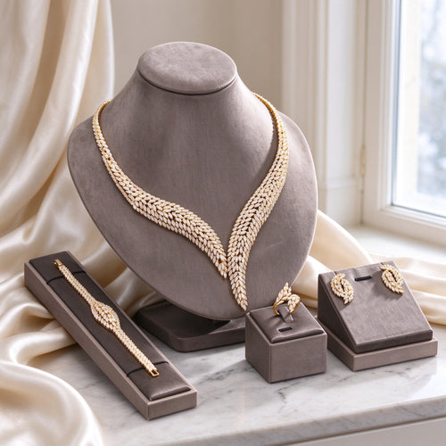 The Dawn Bridal Parure gold-tone marquise CZ necklace set on warm grey velvet bust