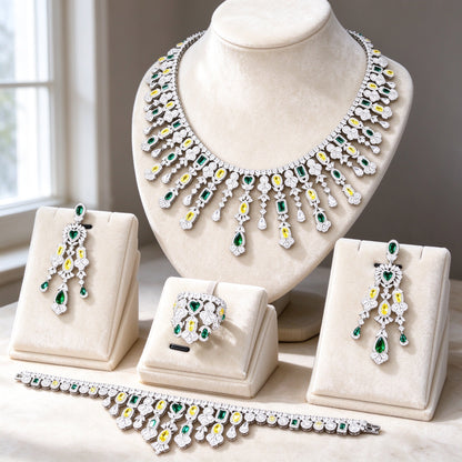 The Dahlia Crystal Parure — silver-tone haloed colored-stone collar necklace, chandelier earrings, bracelet and cluster ring on ivory velvet