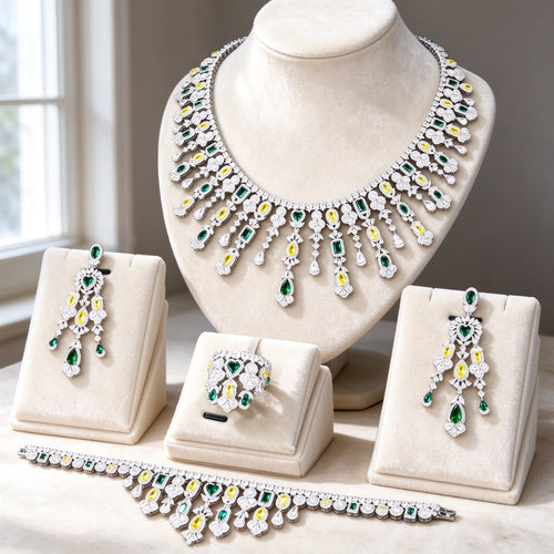 The Dahlia Crystal Parure — silver-tone haloed colored-stone collar necklace, chandelier earrings, bracelet and cluster ring on ivory velvet