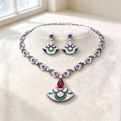 The Camellia Bridal Parure — silver-tone Art Deco fan collarette necklace with amethyst-purple ovals, emerald-green arcs and ruby-red teardrop fan pendant, matching drop earrings on ivory velvet