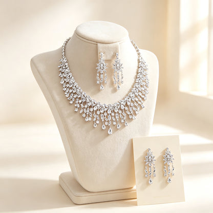 The Vivienne Bridal Parure — silver-tone cascading marquise and pear CZ fringe bib necklace with chandelier drop earrings on an ivory velvet bust