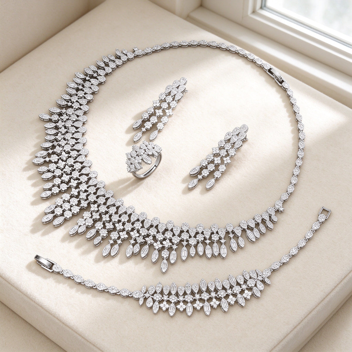 The Dusk Wedding Suite — cascading CZ bib necklace set on ivory