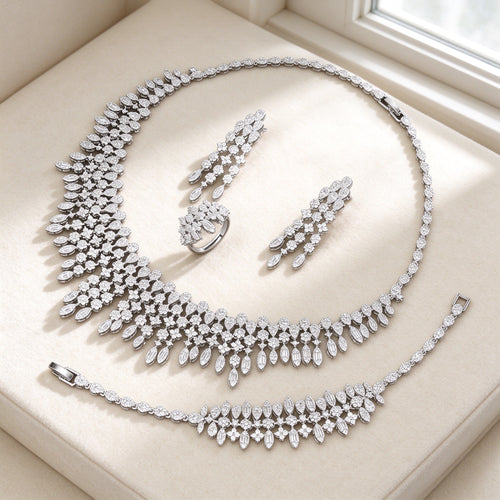 The Dusk Wedding Suite — cascading CZ bib necklace set on ivory