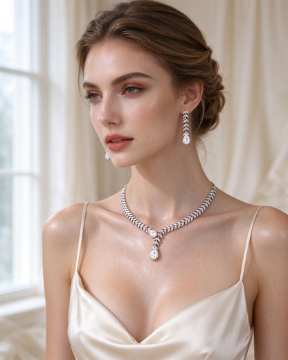 The Stem Crystal Parure — laurel leaf cubic zirconia bridal necklace and earrings on a bride in ivory silk