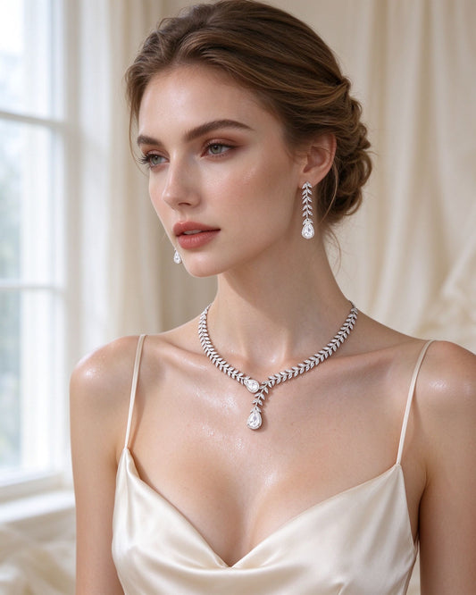 The Stem Crystal Parure — laurel leaf cubic zirconia bridal necklace and earrings on a bride in ivory silk