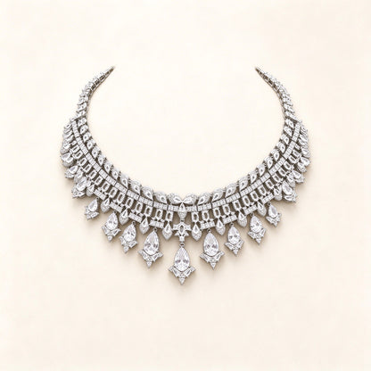 The Quinn Crystal Parure – silver-tone pavé CZ articulated collar bib necklace with pear-drop fringe on ivory