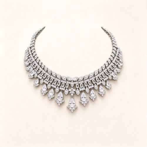 The Quinn Crystal Parure – silver-tone pavé CZ articulated collar bib necklace with pear-drop fringe on ivory