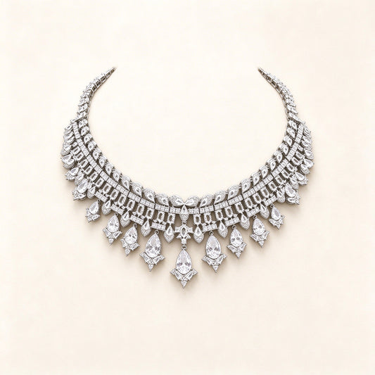 The Quinn Crystal Parure – silver-tone pavé CZ articulated collar bib necklace with pear-drop fringe on ivory