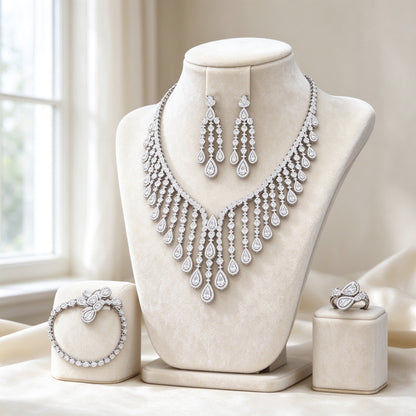 The Ember Bridal Set — 4-piece silver-tone CZ bridal jewelry set on cream velvet bust