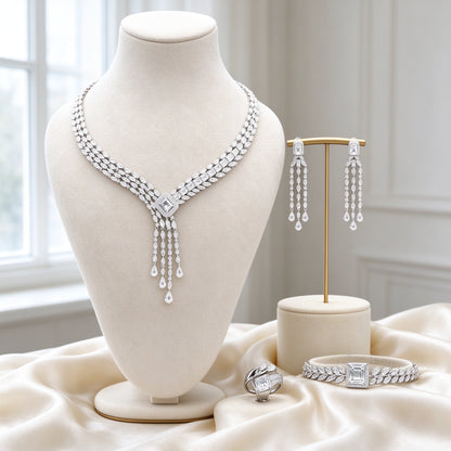 The Harvest Bridal Parure silver-tone CZ tassel collar necklace, chandelier earrings, bypass ring and leaf bracelet on ivory silk
