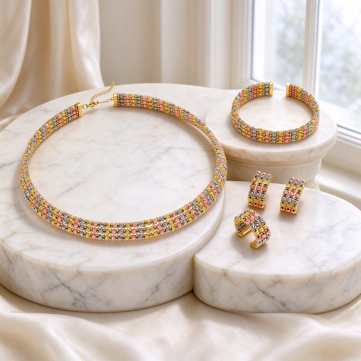 The Emerson Wedding Suite - tri-tone woven bead choker collar, open-cuff bangle, cluster earrings and ring on ivory marble pedestals