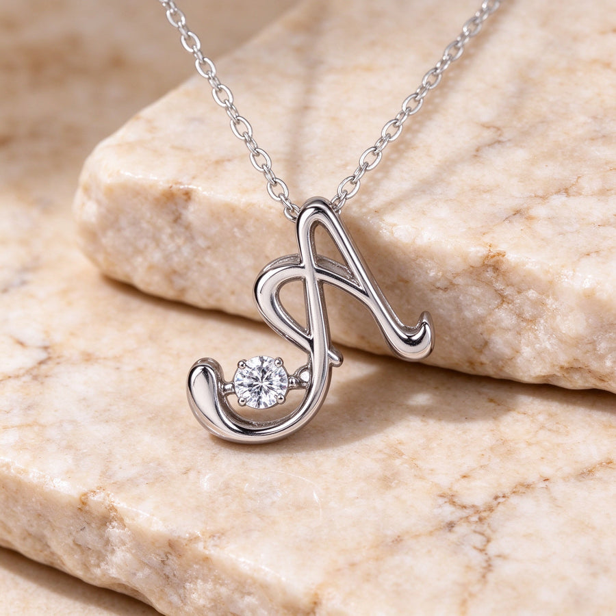 Close-up macro of sterling silver script letter A pendant with sparkling cubic zirconia