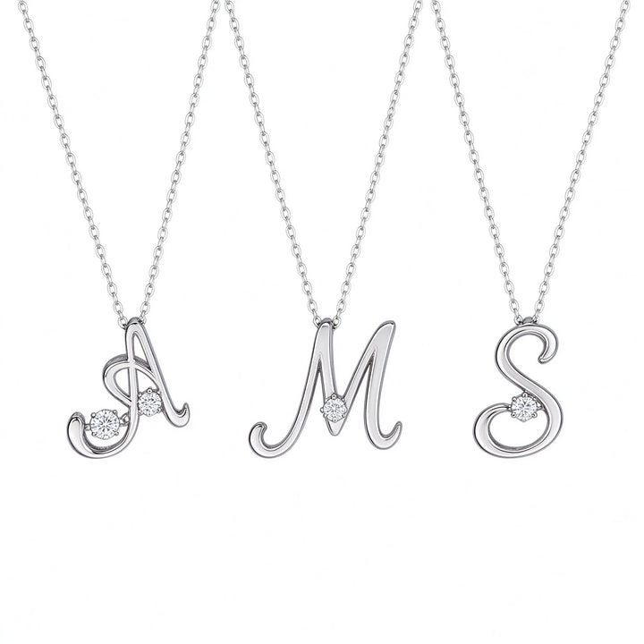 Three dainty sterling silver initial necklaces in letters A, M and S side by side