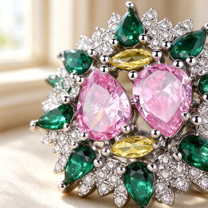 Macro of the Hazel statement ring with two pear pink CZ centers and green marquise stones