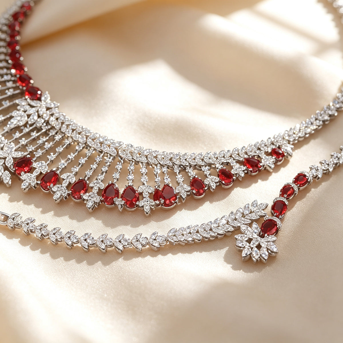 Macro detail of pavé CZ lattice and dangling ruby pear drops