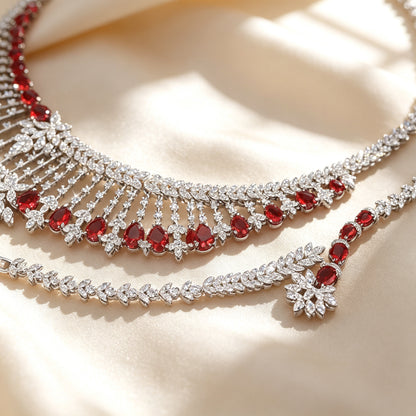 Macro detail of pavé CZ lattice and dangling ruby pear drops