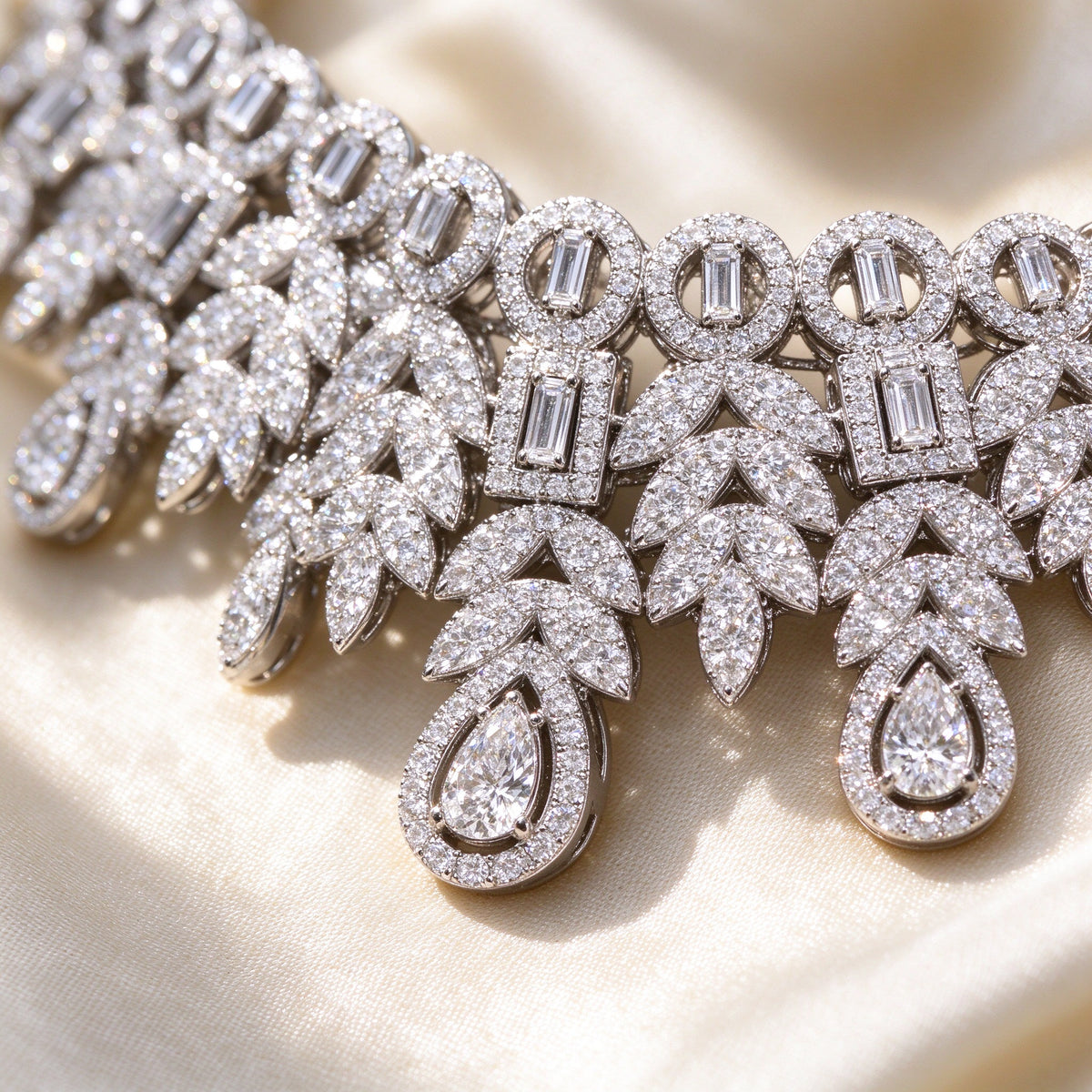Macro of The Lyra Crystal Parure openwork detail with alternating round pavé circles, baguette links and teardrop drops