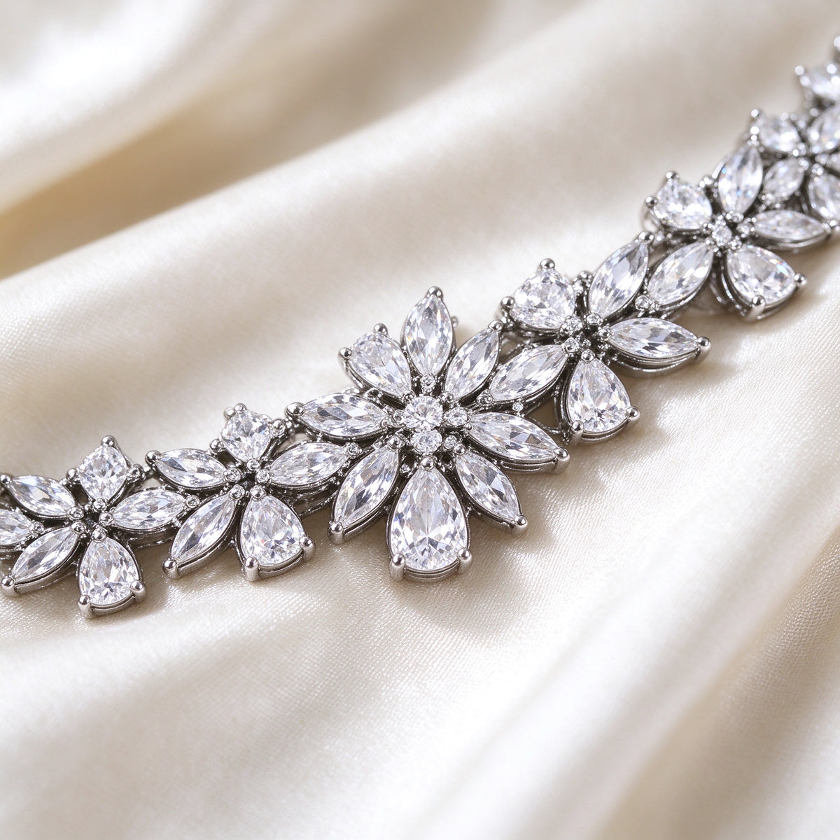 Macro detail of The Meadow Wedding Suite marquise and pear-cut CZ floral cluster