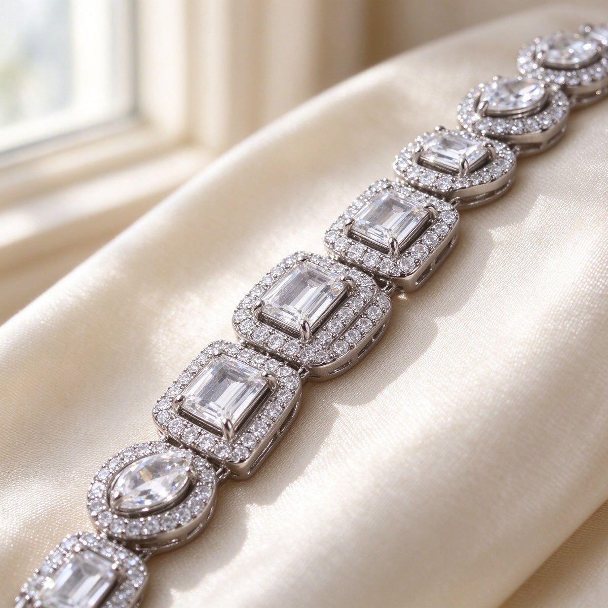 Macro detail of The Celestia Wedding Suite alternating emerald and pear cut CZ with micro-pavé halos