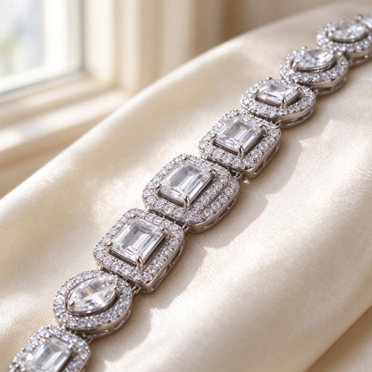 Macro detail of The Celestia Wedding Suite alternating emerald and pear cut CZ with micro-pavé halos
