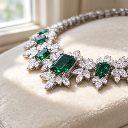 Macro detail of an emerald-green emerald-cut rectangular CZ surrounded by a clear leafy CZ halo on The Twilight Bridal Parure necklace