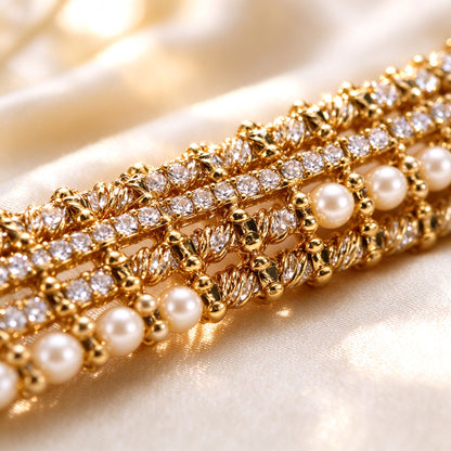 Macro close-up of the gold-tone woven micro-pavé clear CZ and cream pearl bead texture