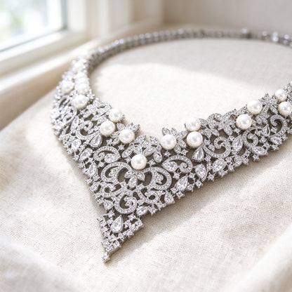 Macro detail of The Grain Bridal Set necklace filigree scrollwork, pavé CZ and graduating pearls