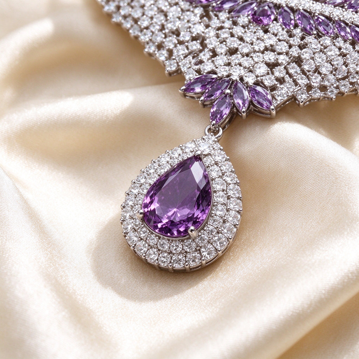 Macro of The Branch haloed pear amethyst pendant and marquise leaf branches