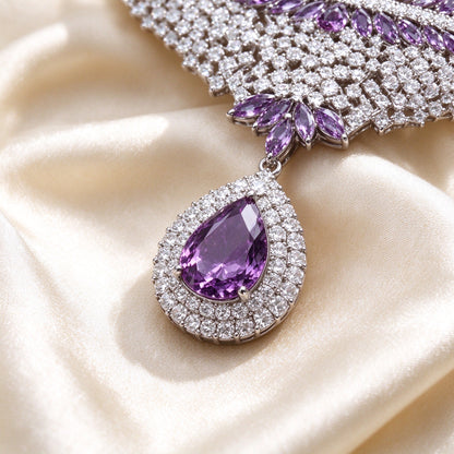 Macro of The Branch haloed pear amethyst pendant and marquise leaf branches