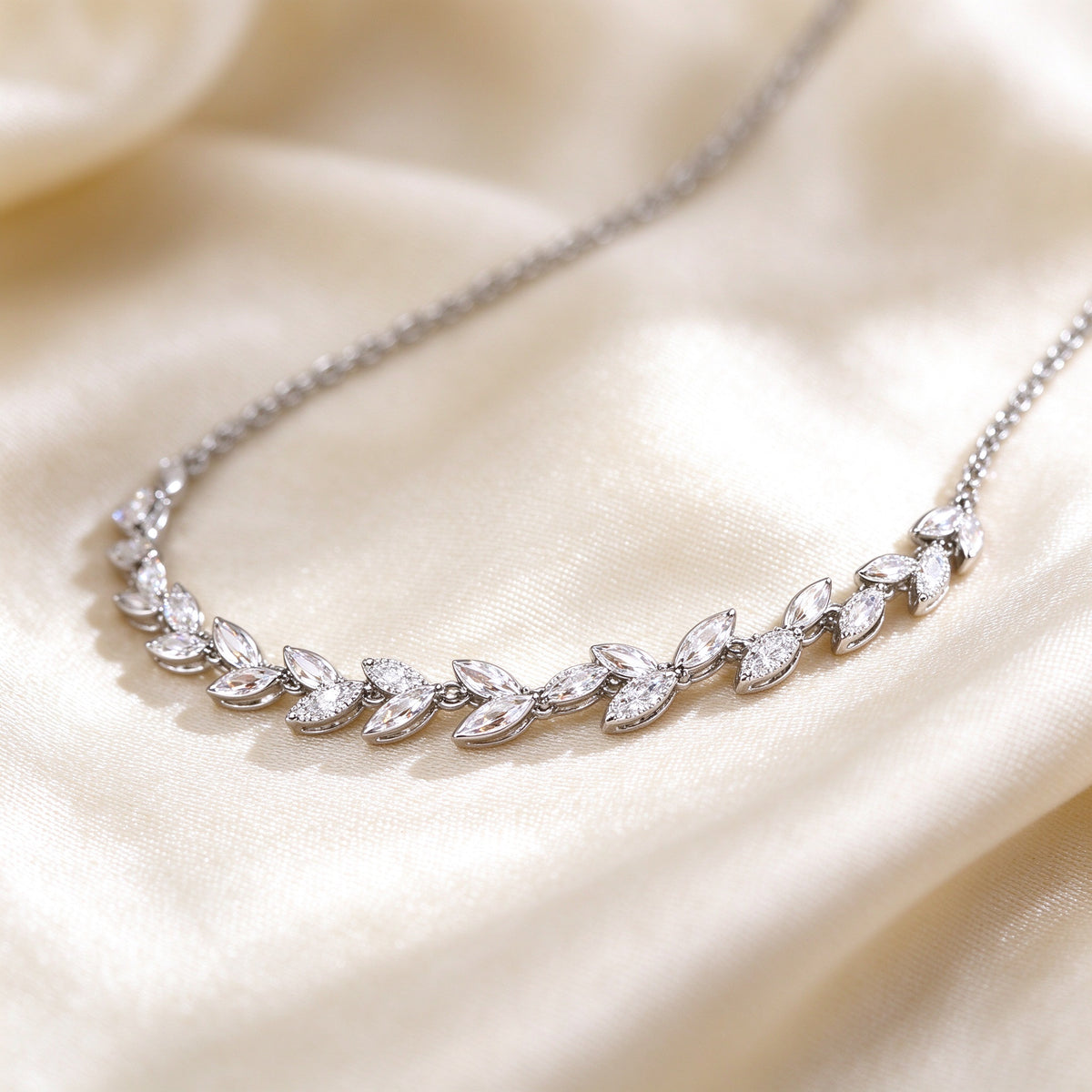 Macro of continuous marquise CZ laurel leaf chain on silk