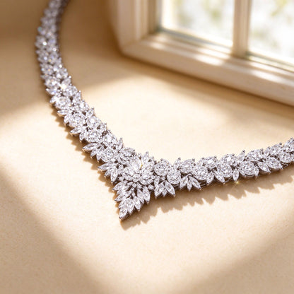 Macro close-up of The Blair graduated marquise-cut clear cubic zirconia V-line on cream silk